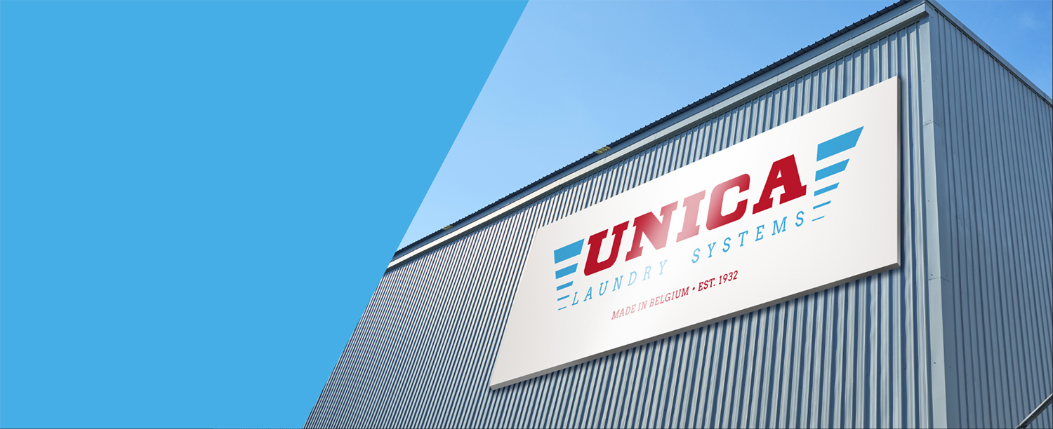 The Unica building in Merchtem with the sign Unica Laundry Systems, made in Belgium, est. 1932